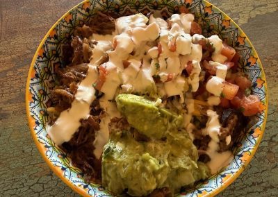 burrito bowl with carnitas and quagomole add on