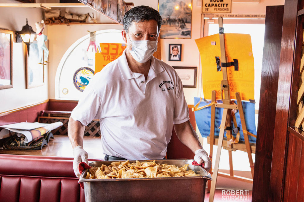 Gilberts El-Indio Robert Sturman Guy Holding Tortilla Chips Gilberts El-Indio Robert Sturman Guy Holding Tortilla Chips