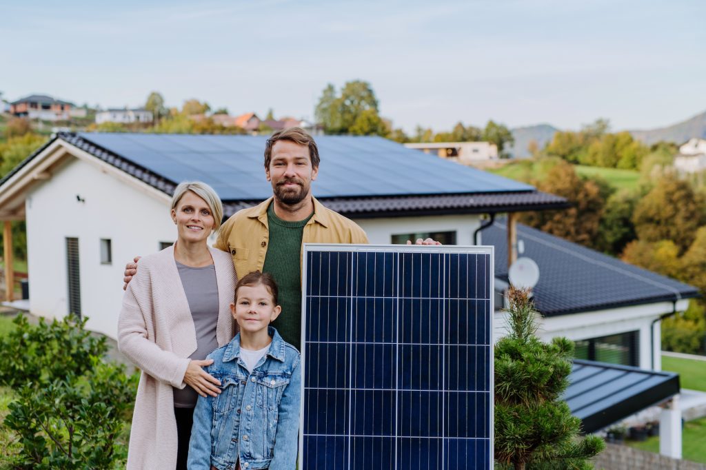 Happy family near their house with solar panel Lafayette California