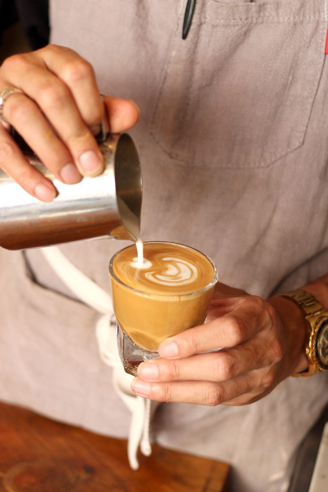 man pouring latte in san francisco